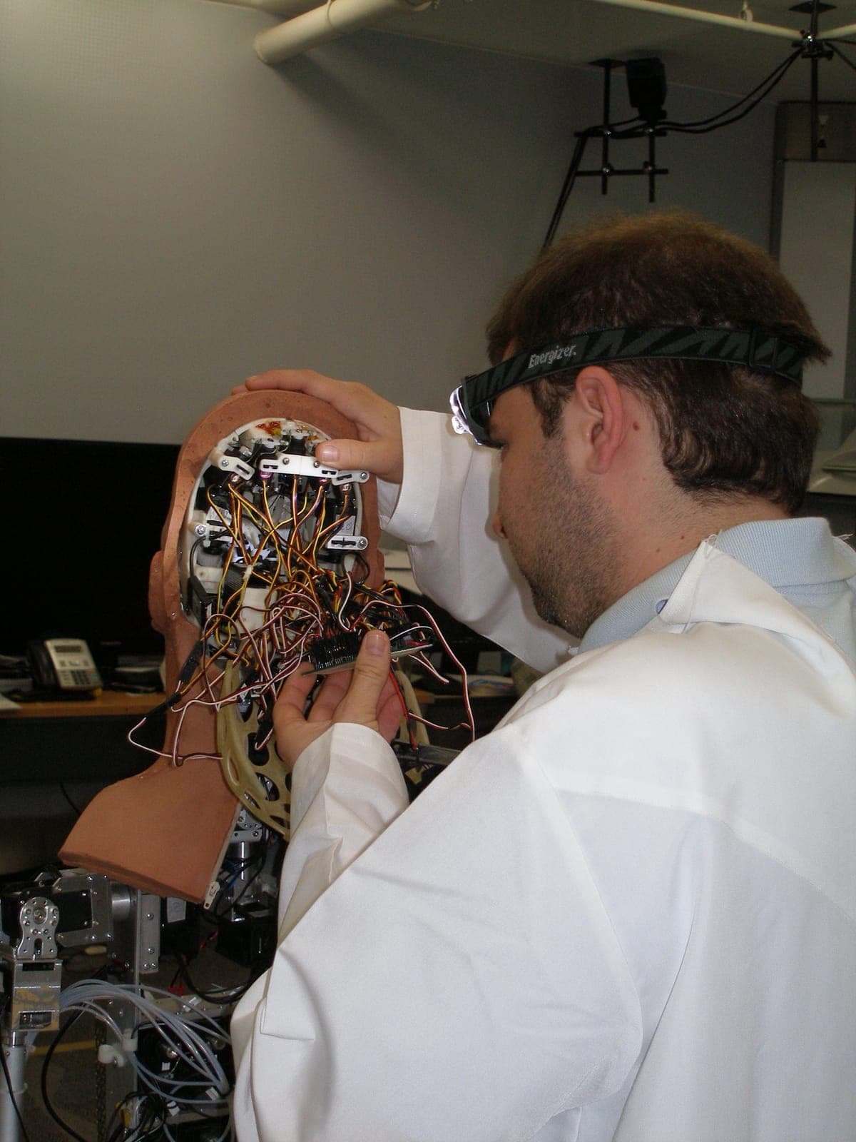Rear of the android robot head opened for service, revealing the servo actuation and wiring loom