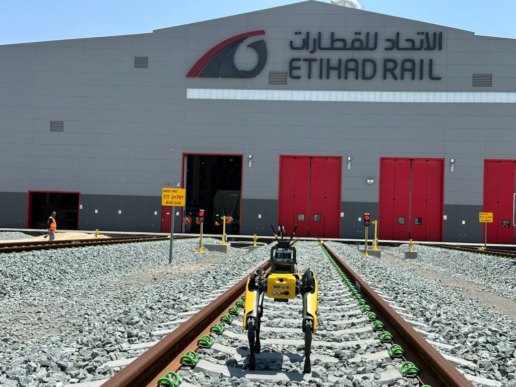 Spot on railway tracks facing the Etihad Rail depot, gathering multimodal data for locomotive predictive maintenance analysis