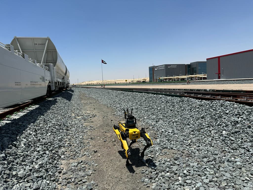 Spot in the Etihad Rail yard between freight tracks, supporting multimodal data collection for further analysis and predictive maintenance