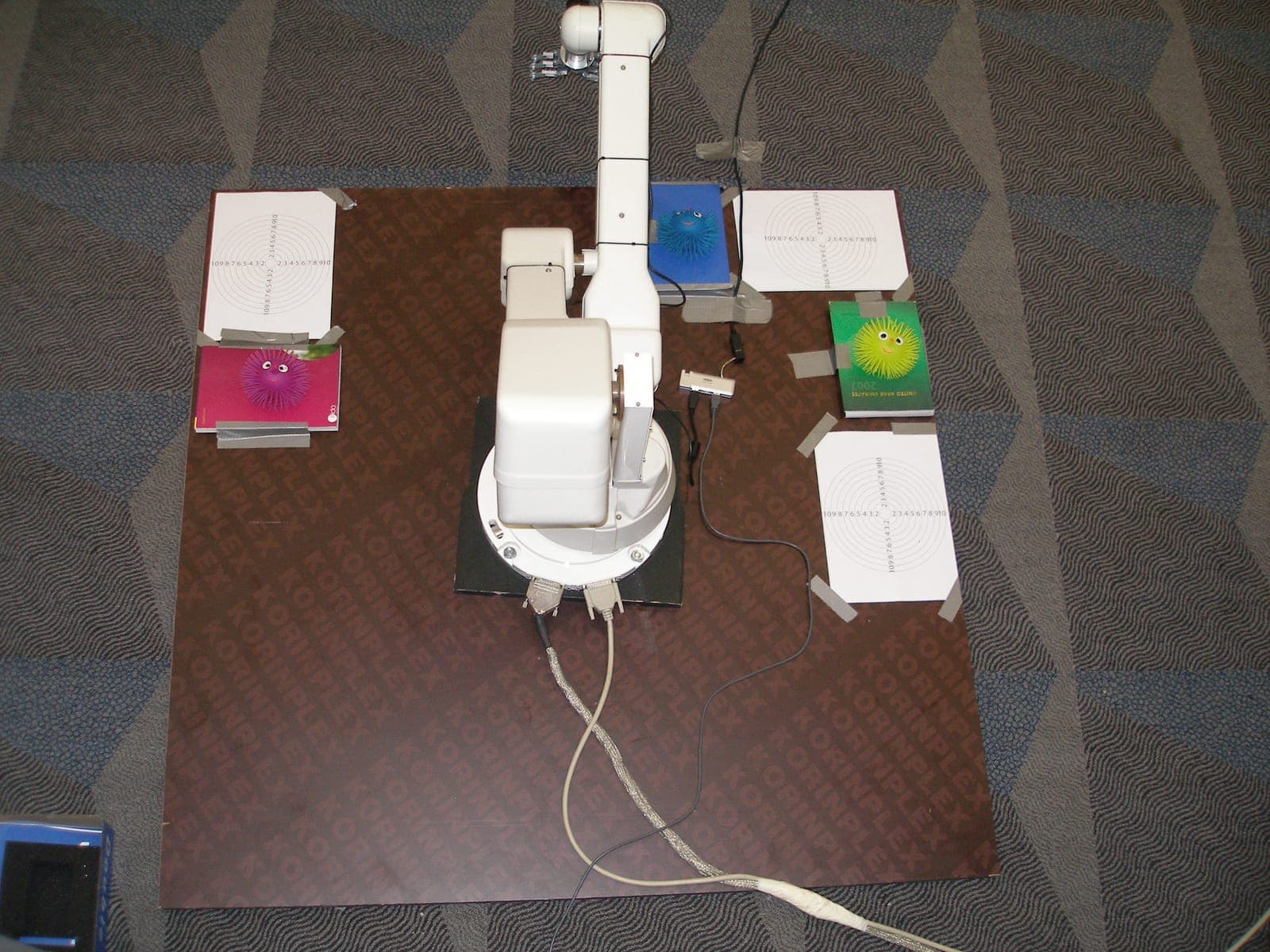 Top-down view of the industrial robotic arm on its test field, surrounded by reach targets